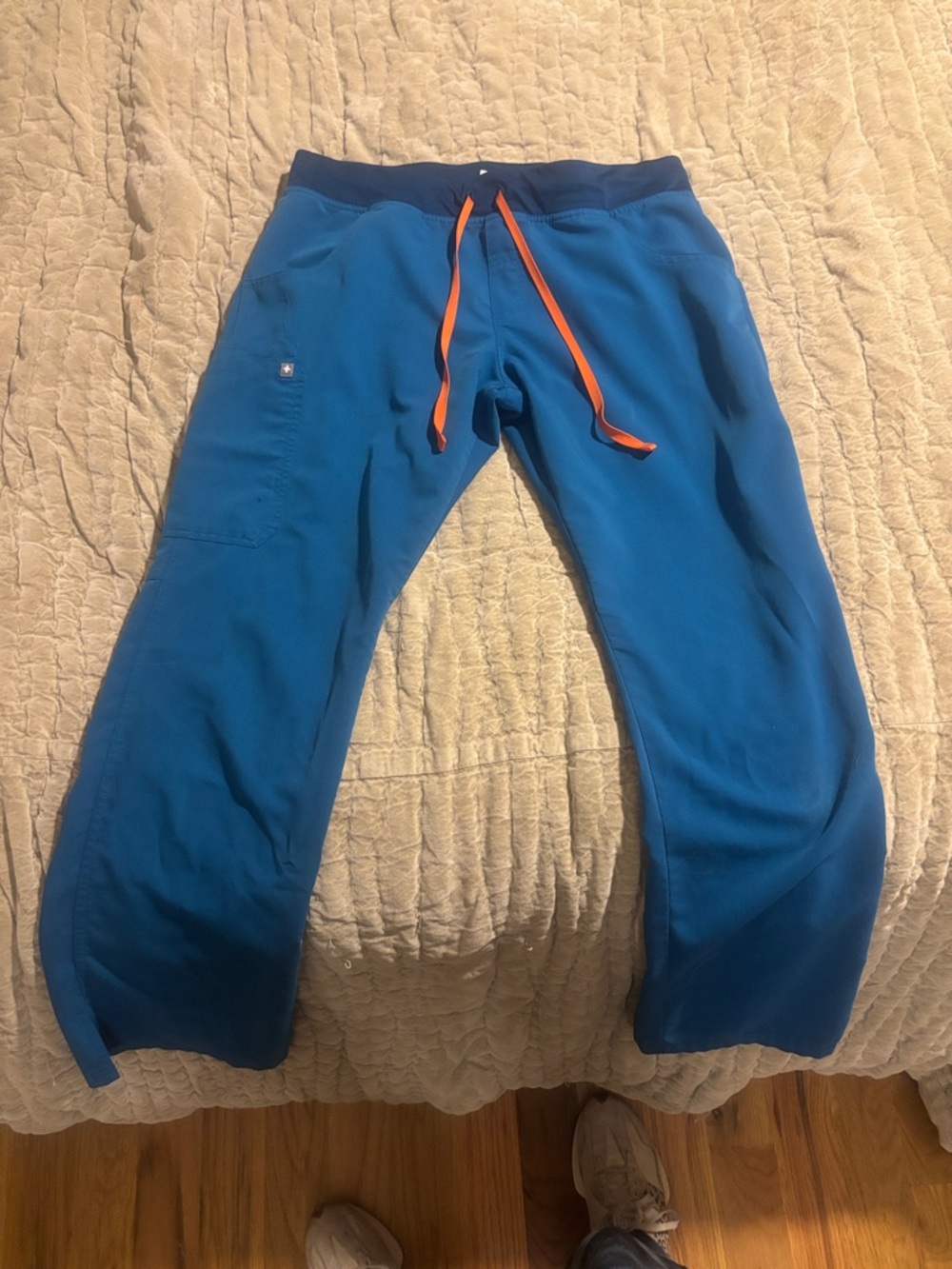 Women’s figs Kade Scrub pants in Caribbean Blue with orange drawstring